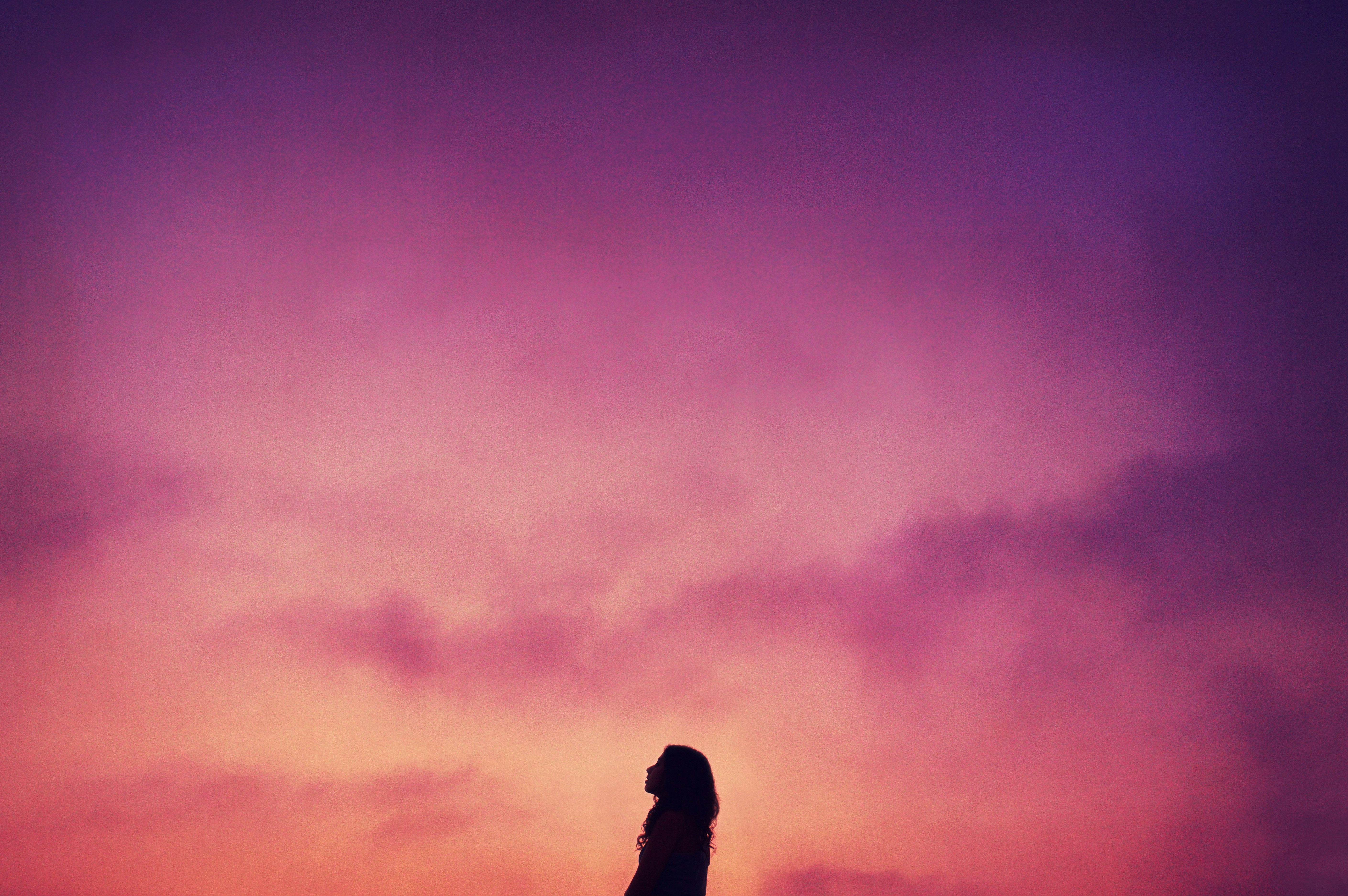 A solitary figure silhouetted against a soft violet sky. The quiet return to yourself.